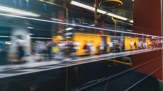 Subway train in motion with the reflection on the glass of the standing people in Frankfurt, Germany