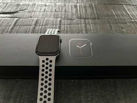 Karlsruhe, Germany – September 25, 2022: A view of the Apple Watch Serie 5 Nike Edition on Its Box, on dark wooden background