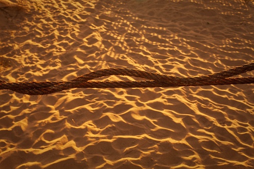 A closeup shot of a brown rope on the beach in Espinho, Portugal