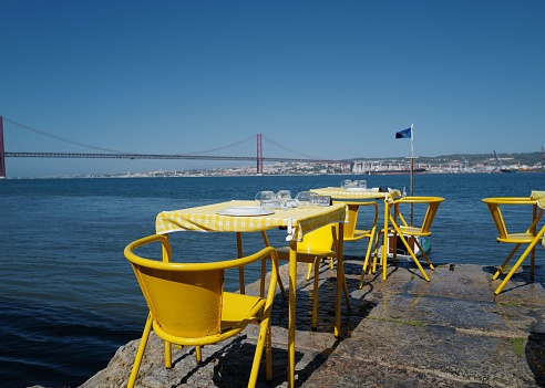 Outdoor restaurant with view to the 25 April bridge in Lisbon