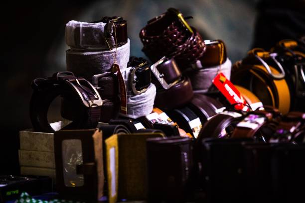 istock Selective focus shot of leather belts and wallets on a dark background 1447311016