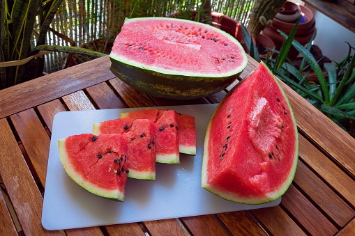 Fresh sweet watermelon on market stall as background. Ripe freshly picked water melons pile at farmers market