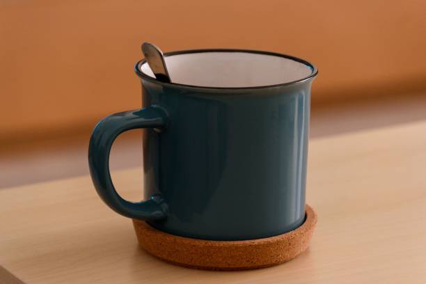 istock Close-up view of a spoon inside the blue mug on a coaster 1447311440