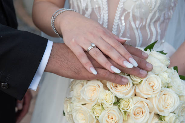 istock the bride shows her engagement ring on the bride's bouquet 1447311451