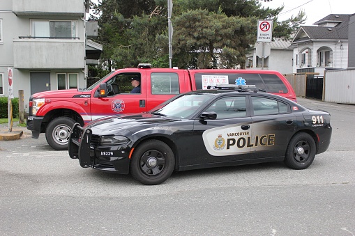 Vancouver, Canada – June 25, 2022: A firefighter truck and a police car in Vancouver, Canada