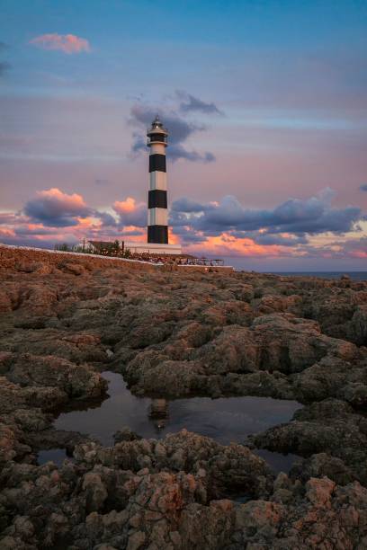 istock Vertical shot of a lighthouse against a cloudy sky during the sunset 1447312315