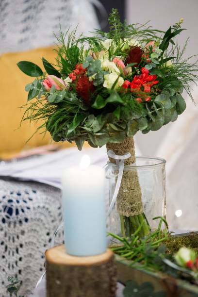 istock Lighted candle and bouquet for decoration 1447315830