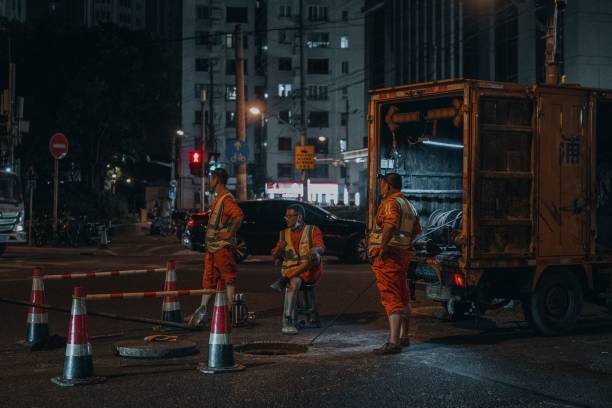 S, China – August 28, 2022: The road workers working hard throughout the night