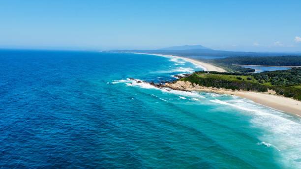 istock Blue ocean with waves hitting the sand of the beach 1447316544