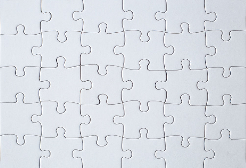 A Full-frame photograph of a white jigsaw puzzle