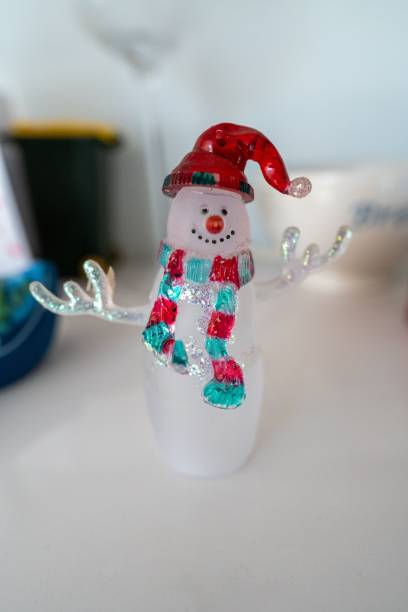 istock Vertical closeup shot of a snowman on the table 1447317347