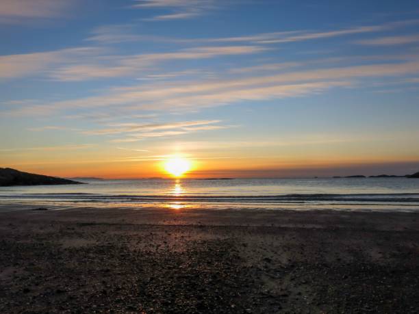 istock Beautiful shot of a seascape under the orange sunset 1447317543