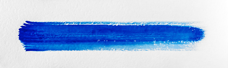 Blue paint stroke on a white textured paper.