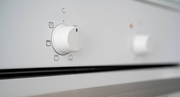 istock Close up of the buttons/regulators on a white stove kitchen 1447320923