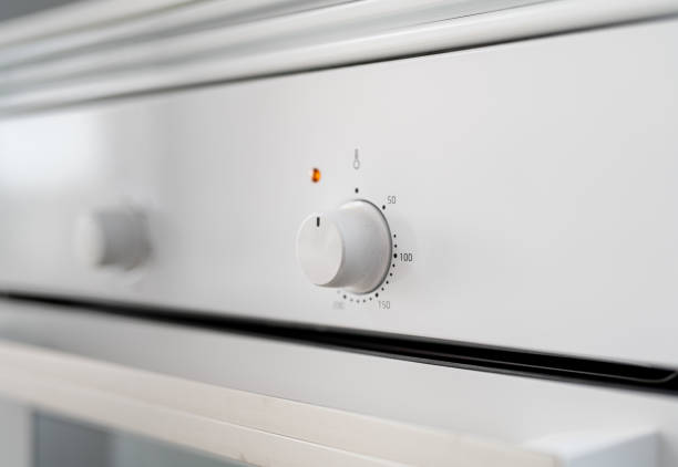 istock Close up of the buttons/regulators on a white stove kitchen 1447320945