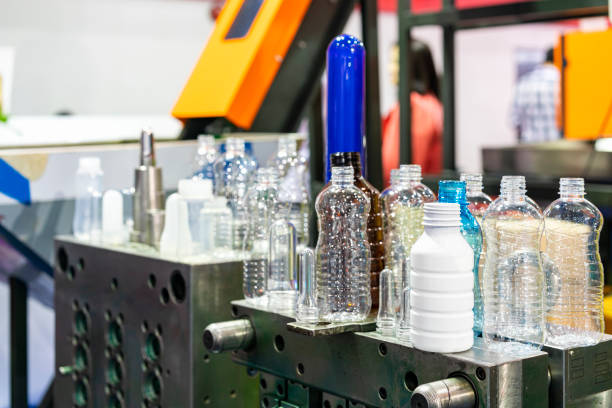 istock various sample transparent plastic bottle and other color with  preform raw material place on metal mold of manufacturing process bottle blowing in industrial 1447321311