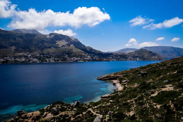 istock Telendos island in Greece surrounded by blue seascape against a sky with fluffy clouds 1447321948