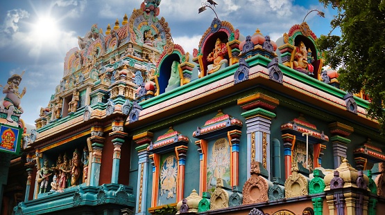 The exterior design of Pondicherry India Hindu temple in full colors and vibrance with the sun shining