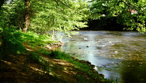 istock Abundant river flowing through a park on sunny day with trees on both sides, Brive la Gaillarde 1447324223