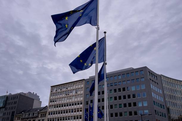 istock European Union flags waving outdoors with a cloudy sky in the background 1447324248