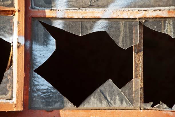 istock A broken window on an old building with rusty metals 1447327071