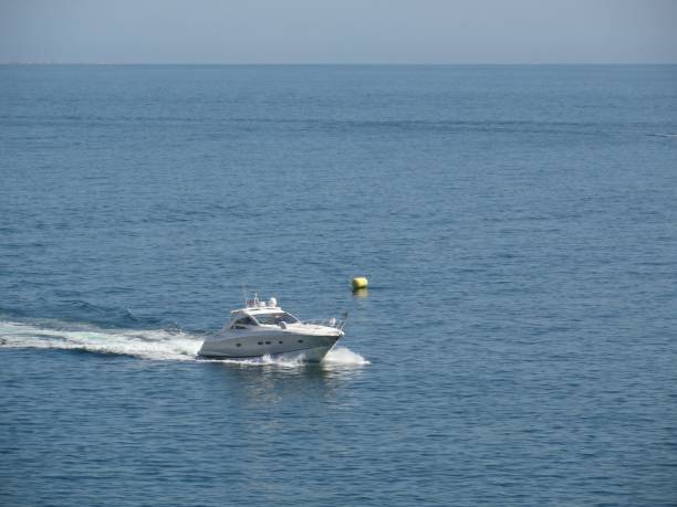 istock White boat on the water surface against a blue sky 1447329212
