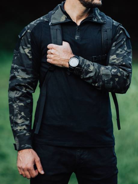 istock Caucasian man in a black military uniform in a forest 1447329347