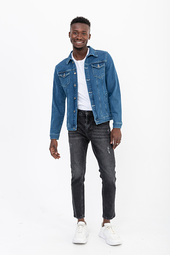 Black male model wears a denim jacket and is in front of a white background.