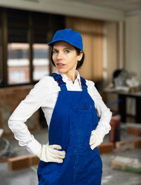 istock Woman construction worker posing inside house under renovation 1447331157