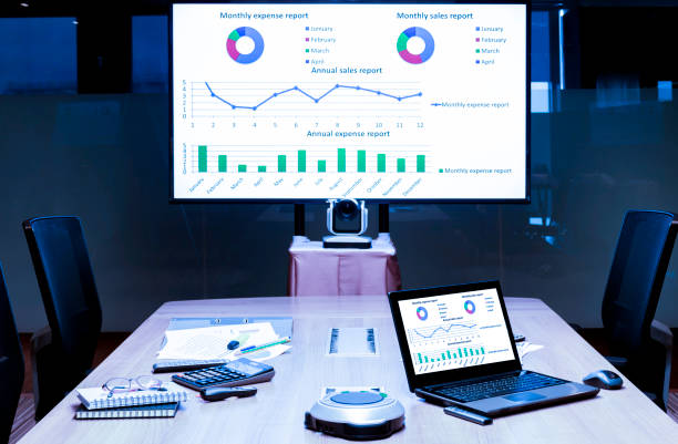istock Mock up presentation on display television and laptop on table in meeting room 1447331593