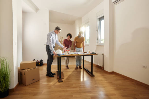 istock African American couple analyzing housing plan with an architect. 1447339060