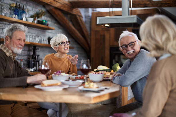 istock Happy nature friends talking during lunch in dining room. 1447339750
