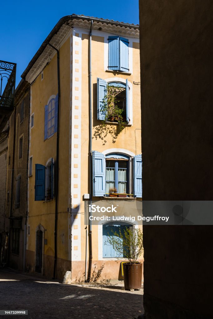 Play of shadow and light on a facade of a building in the historic center of Sauve Ancient Stock Photo
