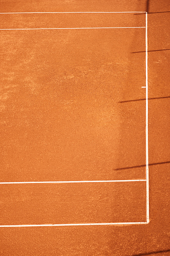 Aerial view of an empty clay tennis court. Copy space