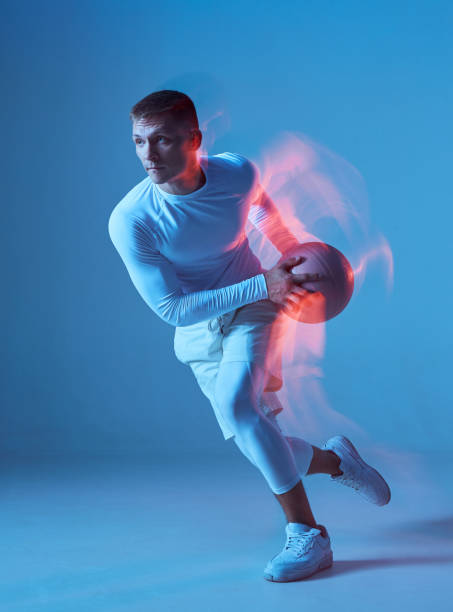 istock Basketball player on blue background in action shot. 1447342107