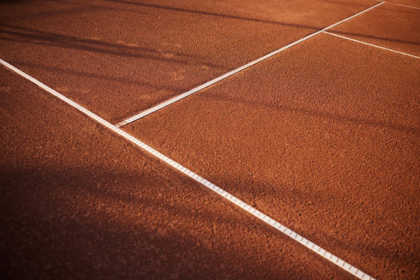 White tennis lines on red clay court No people in this aerial view of white lines of red clay tennis court. Copy space clay court stock pictures, royalty-free photos & images