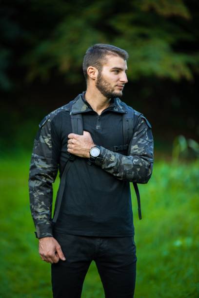 istock Caucasian man in a black military uniform in a forest 1447342291