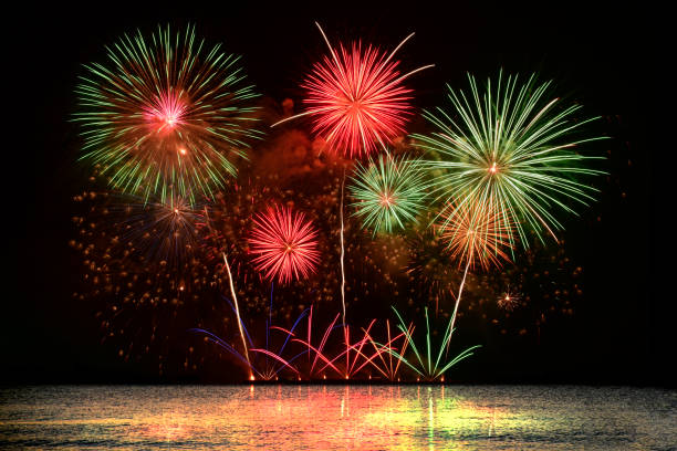 istock Colorful fireworks celebration from the sea with the midnight sky 1447343308