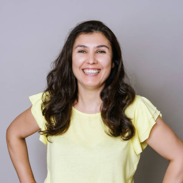 istock Real woman smiling portrait, studio shot 1447343476
