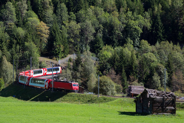 Glacier Express train at Fiesch (Valais, Switzerland) Glacier Express train at Fiesch (Valais, Switzerland). Railway between Sankt Moritz, Davos and Zermatt. graubunden canton stock pictures, royalty-free photos & images