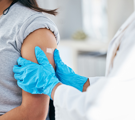 Doctor, vaccine and patient arm, plaster and medical healthcare for flu shot, hpv and covid 19 risk in clinic hospital. Corona virus consulting, wellness service and bandage treatment for immunity
