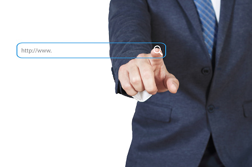 Businessman Touching Magnifier Icon In Search Box on virtual screen , Internet technology concept