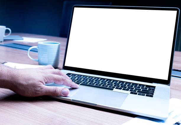 istock Businessman hand pressing keyboard laptop with mock up sales summary slide show presentation on display laptop and coffee cup on table in meeting room 1447346592