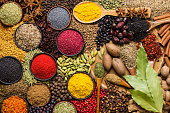 food background, spices and herbs for cooking tasty dishes. various seasonings scattered on table.