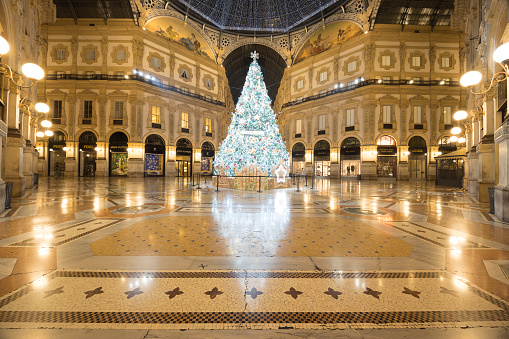 Milan, Italy - December 7, 2022: wide angle street view of Galleria Vittorio Emanuele II decorated for Christmas, no people are visible.