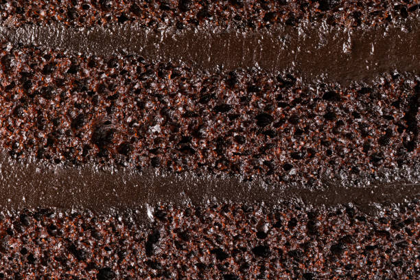 Texture of chocolate sponge cake. Extreme closeup side view of texture of delicious chocolate sponge cake background, horizontal full frame format. chocolate cake stock pictures, royalty-free photos & images