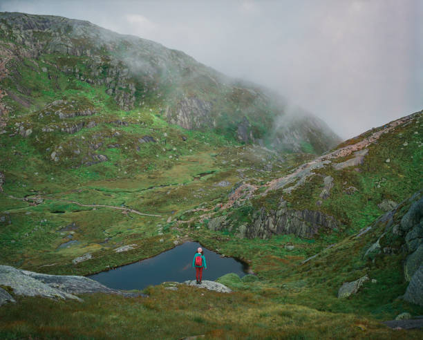 Young Caucasian woman  hiking  in Norwegian highlands