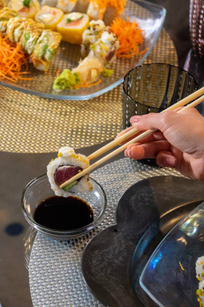 istock Sushi on the table with hand and chopsticks 1447352445