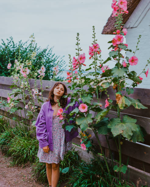 Portrait of young Caucasian woman   standing in flowers