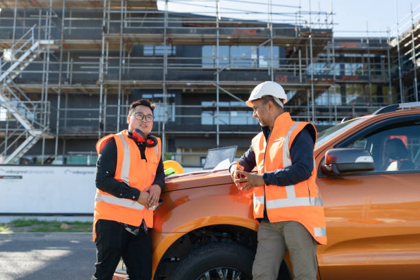 construction workers construction workers discussing plan for a site kiwi says stock pictures, royalty-free photos & images